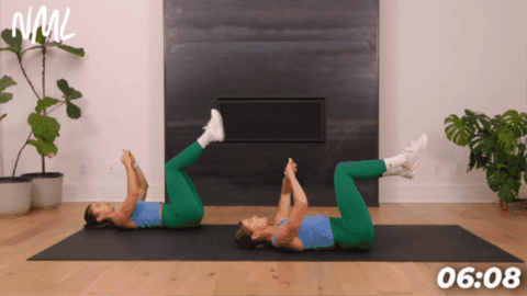 women performing alternating leg kickouts as example of ab exercises in 10 minutes