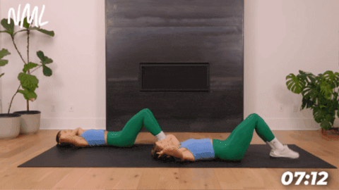 two women laying on a black mat performing a half crunch with one leg lifted as part of 10 minute core workout