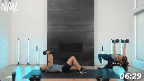 woman on bench performing chest fly as part of chest and legs workout