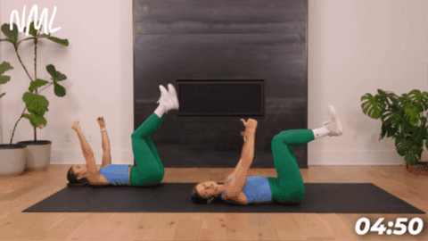women performing a dead bug exercise on black exercise mat to target deep core