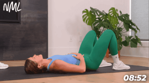 woman lying on her back performing 360 breathing to activate deep core