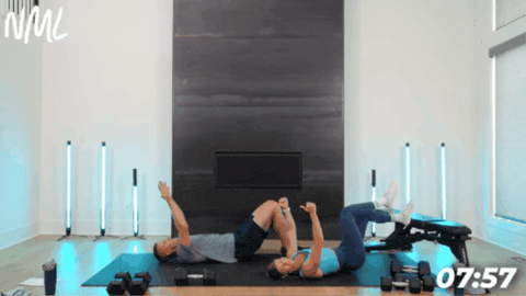 man and woman performing a hamstring glute bridge 
