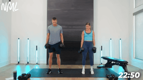 man and women performing squats with heels elevated as part of chest and leg workout