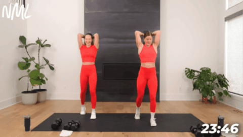 women in red athletic wear performing overhead tricep extensions to target the arms