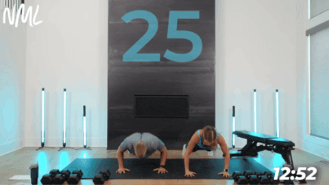 couple performing push ups together as part of chest and legs workout