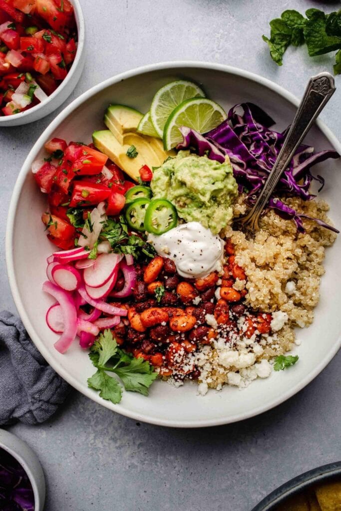 Quinoa Taco Bowls with black beans, taco seasoning, Guacamole, Avocado and fresh lime.