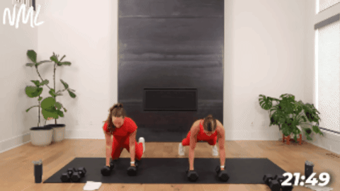 adult women performing a push up and single arm back row as part of compound arm workout