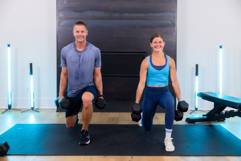 husband and wife performing a reverse lunge as part of chest and leg workout