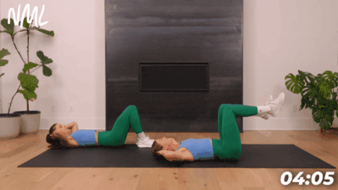 2 women on exercise mat performing slow bicycle crunches as part of 10 minute core workout