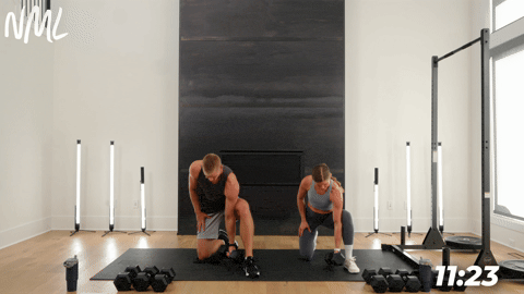 two people performing concentration curls in a back and bicep workout