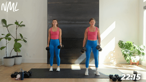 two women demonstrating bicep curls in a full body strength circuit workout