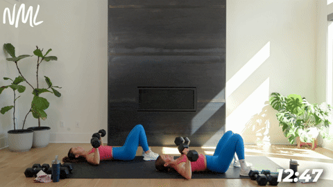 two women demonstrating a chest press in a full body strength circuit workout