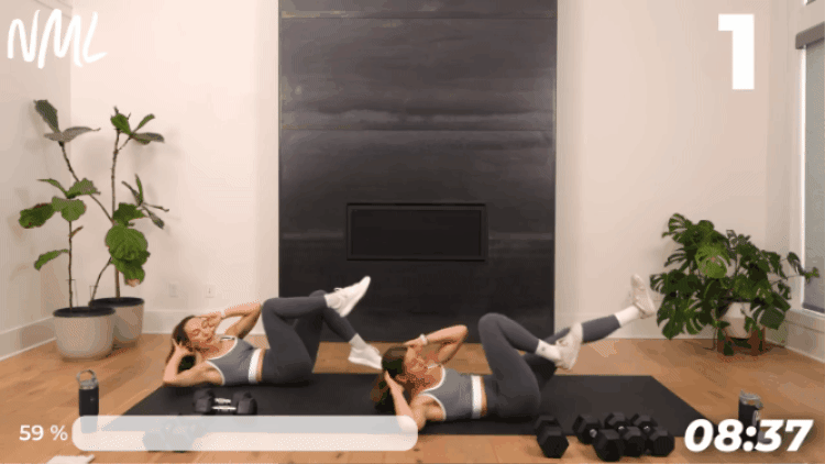 women laying on their backs performing alternating bicycle crunches in Exercise After Being Sick workout routine