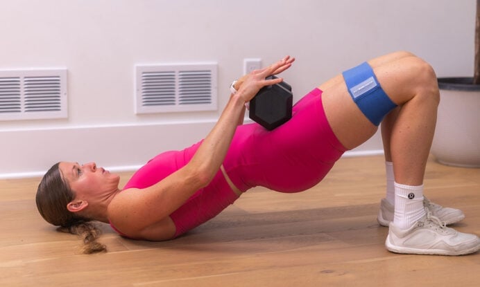 woman performing hip thrust as part of glute workout at home