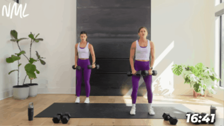 women performing a lateral raise as part of arm and ab supersets