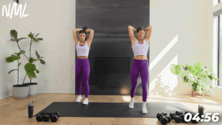 two women performing an overhead tricep extension with single dumbbell