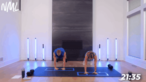 husband and wife performing a push up with shoulder tap as part of cardio agility workout
