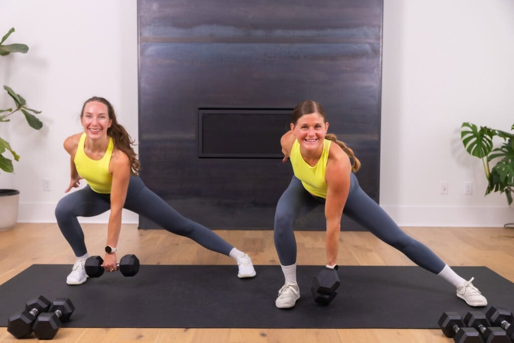 two women performing a lateral lunge as part of quick full body workout at home