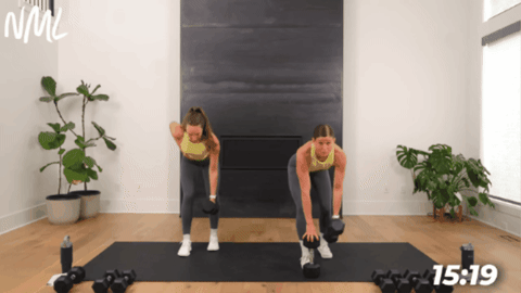 women performing a single arm back row as part of quick home workout