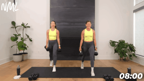 women performing a split lunge with dumbbells
