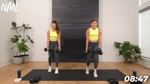 two women performing a staggered deadlift with dumbbells as part of quick full body workout