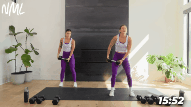 fitness trainer performing a dumbbell chop with a slow lower