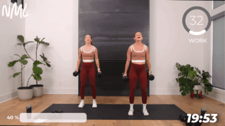 women standing and performing flip grip bicep curls as part of 30 min full body workout dumbbells