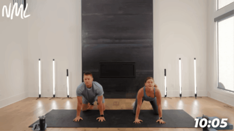 man and woman performing cat cow stretch as part of workout cool down stretching routine