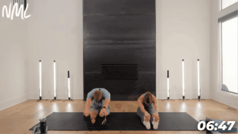 man and woman performing a hamstring and glute stretch as part of workout cool down routine