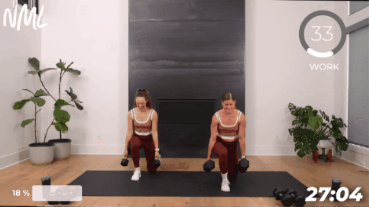 women performing a reverse lunge with a knee drive as part of 30 minute dumbbell workout to target the full body
