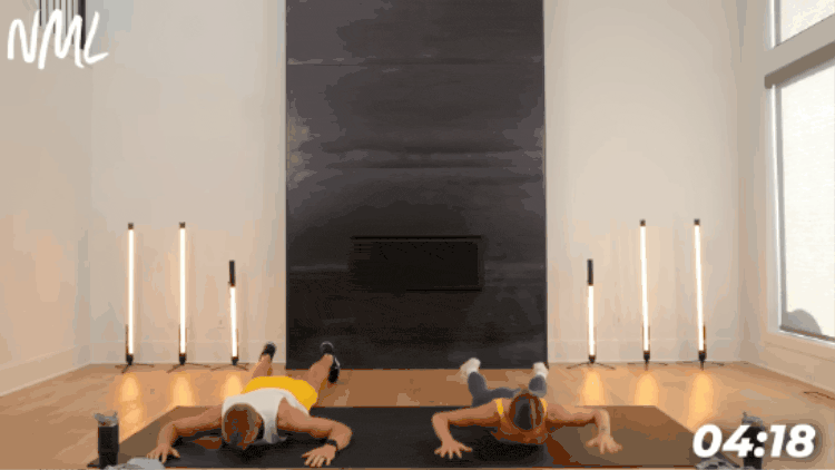 man and women laying on stomachs to perform prone back flys to warm up upper back