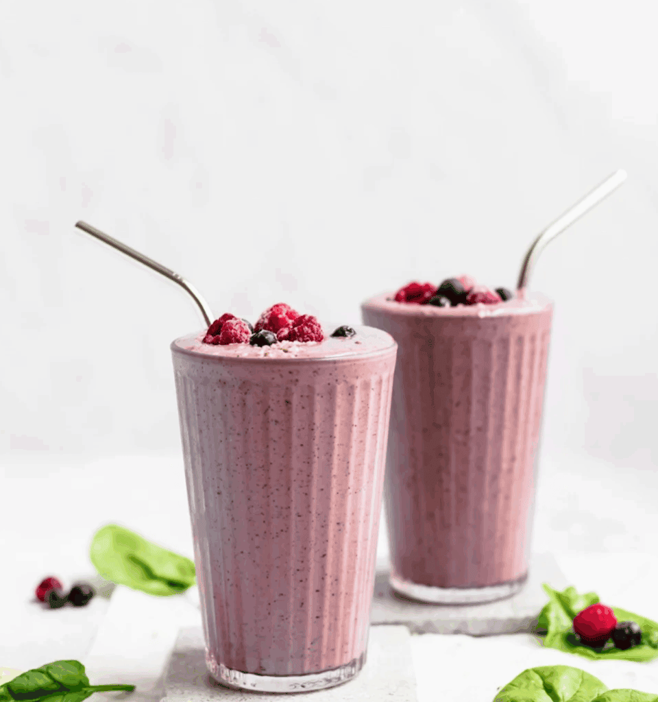 Berry smoothie with blackberries, raspberries, blueberries, banana, spinach, flaxseed, almond butter, greek yogurt and protein powder.
