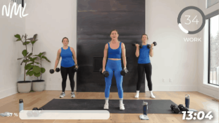 women performing alternating bicep curls as part of beginner strength training routine