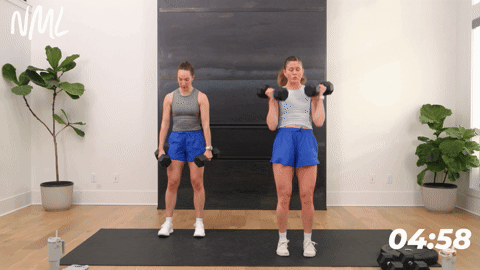 two women performing a deadlift clean and squat in a leg workout at home