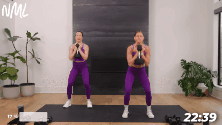 two women in purple performing a goblet tension squat