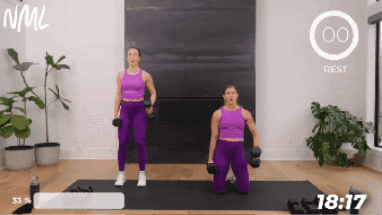woman kneeling to perform bicep curl and shoulder press