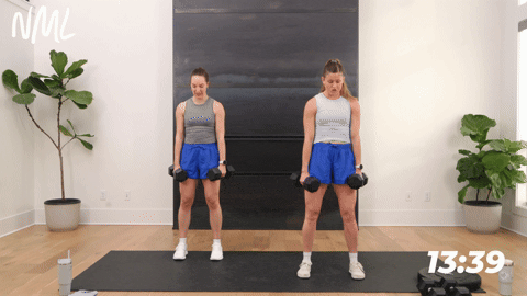 two women performing a loaded squat jump and retraction in a quick leg workout