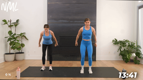 two women performing 360 breathing and overhead arm sweeps in a lymphatic drainage workout