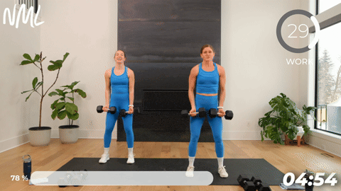two women performing a dumbbell standing chest fly in a 20 minute strength workout