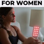 woman in front of red light therapy box explaining popular biohacks for women