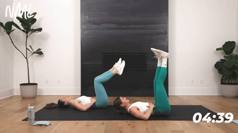 two women performing alternating leg lowers in a beginner core workout