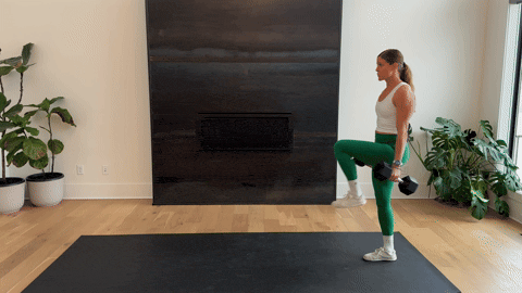 woman performing a farmer carry with dumbbells as part of the best forearm exercises