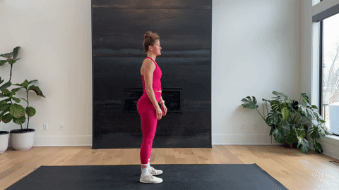 woman performing a forward fold pose as part of the best hamstring exercises