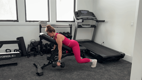 woman performing an incline row with dumbbells as part of the best lat exercises