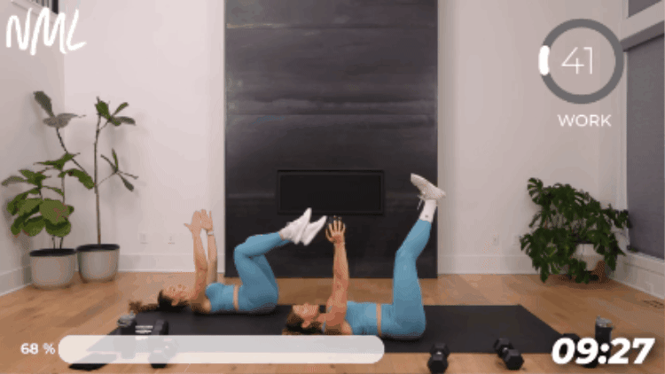 prone women performing leg lowers on black exercise mat