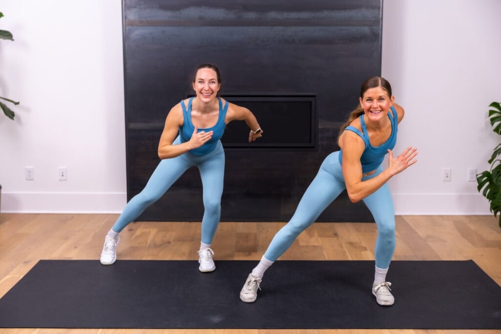 two women performing side steps to show how to get steps in at home