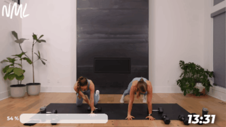 women performing a plank and dumbbell drag as part of core workout with weights