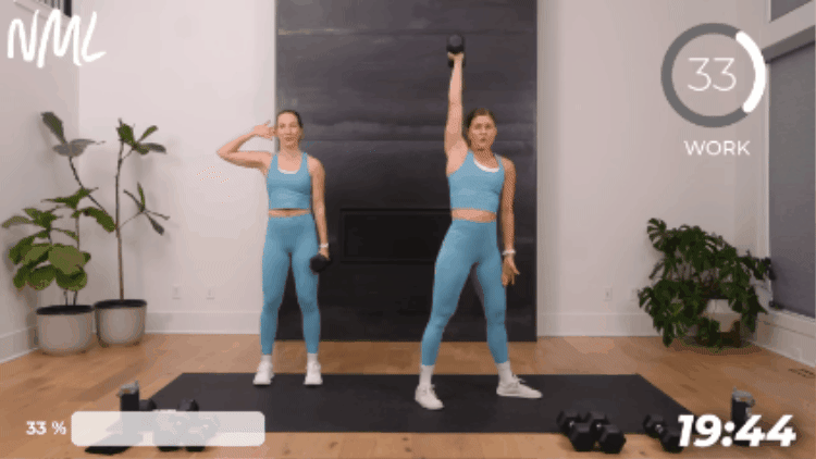 2 women performing a windmill to target obliques as part of core workouts at home roundup 