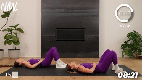 two women performing 360 breathing in preparation to begin a pelvic floor workout