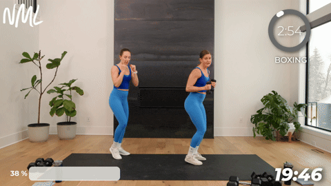 two women performing a jab and cross in a boxing workout at home